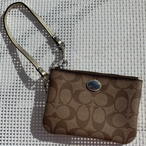 Coach Handbags - Coach wristlet in Signature Canvas with gold trim